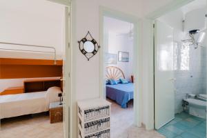 En eller flere senge i et værelse på Villetta Nathalie by BarbarHouse