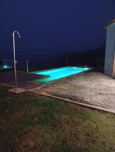 an empty swimming pool at night with a street light at Oak Tree House- Ponta do Pargo in Lombada Velha