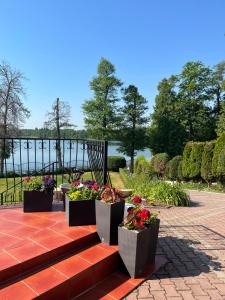 a patio with a bunch of flowers in pots at Eva in Mrągowo