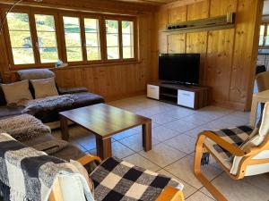a living room with a couch and a tv at Sertig Ferienwohnung in Davos