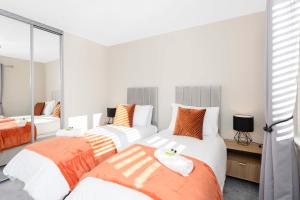 a bedroom with two beds and a mirror at Dunfermline Retreat 3br Wi-fi Private Parking in Townhill