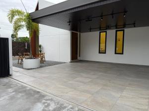an empty patio with a black and white building at Taiping Corner Homestay in Taiping