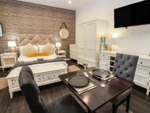 a bedroom with a bed and a table with a dining room at The Railway Apartment in Hexham