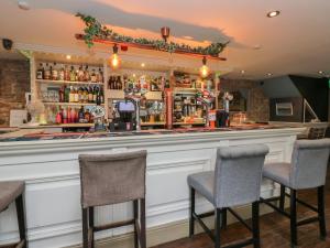a bar in a pub with two chairs at The Railway Apartment in Hexham