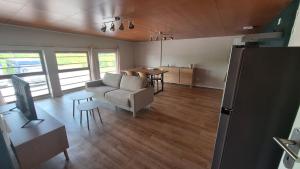 a living room with a couch and a table at Appartement spacieux tout équipé au coeur de l'avesnois in Trélon