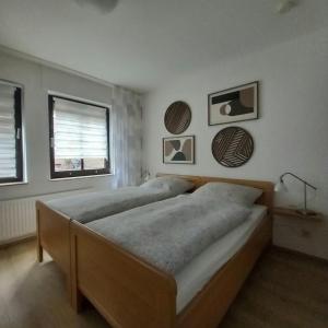 a bedroom with two beds and a window at Ferienwohnung an der Kriemhildmühle in Xanten