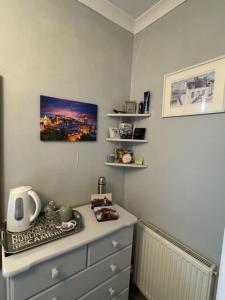 a room with a dresser with acomputer on top of it at Edinburgh Home from Home in EDI