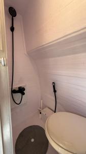a small bathroom with a toilet and a shower at Motorhome RV Oman in Muscat