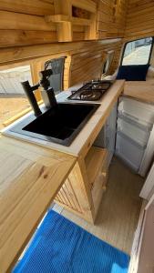 a kitchen in an rv with a sink and a stove at Motorhome RV Oman in Muscat