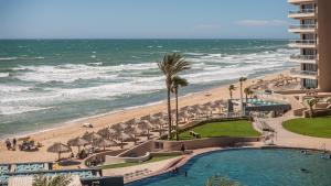 a view of the beach and the ocean from a resort at Rubi 805 1 BR 1BA Condo Phase 1 @ Las Palomas in Puerto Peñasco