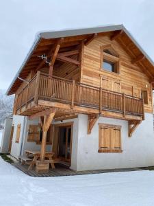a house with a deck on the side of it at Chalet plein sud 10 personnes garage privé cheminée in La Salle Les Alpes