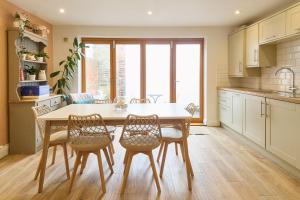a kitchen with a table and chairs in a kitchen at Host & Stay - Aurora in Deal +15 photos