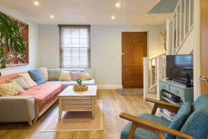 a living room with a couch and a tv at Host & Stay - Aurora in Deal