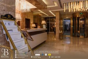 a lobby with a staircase in a building at Bristol Hotel Salalah in Salalah +36 photos