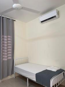 a hospital room with a bed and a air conditioner at Homestay Bajet Kg Telaga Mas Paka in Paka