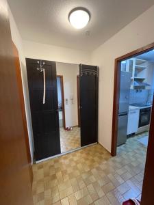 a bathroom with black doors and a kitchen at Unterkirnach in Unterkirnach
