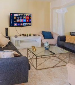 a living room with two couches and a glass table at 3BR Villa Newly Renovated-5 min to Playa Dorada H1 in Puerto Plata