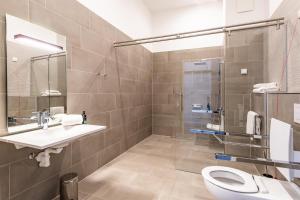 a bathroom with a sink and a toilet and a shower at Premier Inn Wuppertal City Centre in Wuppertal +10 photos