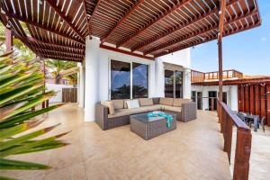 an outdoor patio with a couch and a table at Beautiful 5BR Villa *Zen*Nature*Views*BBQ*BathTub* in Noord