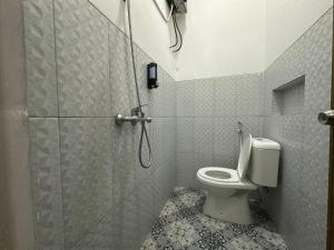 a bathroom with a shower and a toilet at TWD hostel in Malang