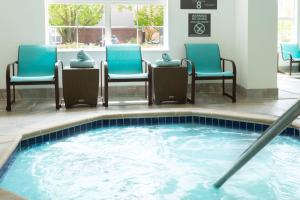a group of chairs and a pool in a hotel room at Residence Inn by Marriott Fort Collins in Fort Collins +17 photos