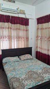 a bed in a room with curtains and a bed sidx sidx sidx at Sea view villa 3 in Kāsaragod