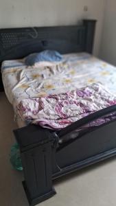 a bed with a blanket on top of it at Sea view villa 3 in Kāsaragod