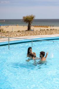 dos personas en una piscina en la playa en Algarve Casino Hotel, en Portimão 116 fotos más