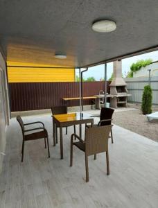 a patio with a table and two chairs and a table and chairsktop at Таунхаус in Košice