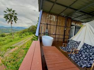 a room with a tub and two chairs on a building at หรรษาวิว ที่พักเขาค้อ เพชรบูรณ์ in Khao Kho +90 photos