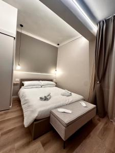 a bedroom with a bed and a table in it at La Pepita - nel cuore del centro in Turin