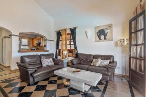a living room with two couches and a table at Villa Tania in Playa Blanca