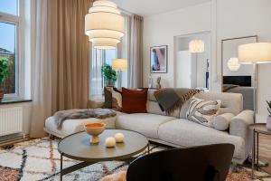 a living room with a couch and a table at Amiralsgatan - City apartments in Malmö