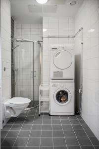 a bathroom with a washing machine and a sink at Amiralsgatan - City apartments in Malmö
