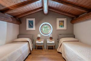 a bedroom with two beds and a window at Villa With Pool And Vineyards Among Etna Vineyards in Santa Maria di Licodia