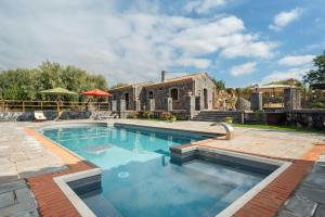 a swimming pool in front of a house at Villa With Pool And Vineyards Among Etna Vineyards in Santa Maria di Licodia