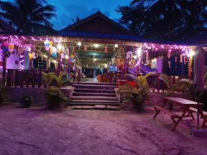 a house decorated with lights and decorations at night at Stay in Paradise Koh Rong in Koh Rong Island