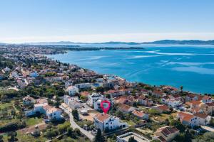 an aerial view of a town next to the water at Villa Paradise in Zadar with 6 bedrooms, pool and gaming room in Zadar