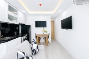 a living room with a couch and a table at Louis Luxury Apartment & Hotel in Danang