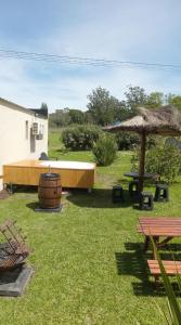 a backyard with a tub and a table and an umbrella at Casa Vida in Sierra de los Padres