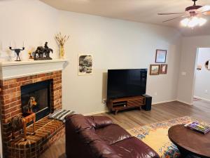 a living room with a couch and a fireplace at Paradise on the Prairie in Oklahoma City