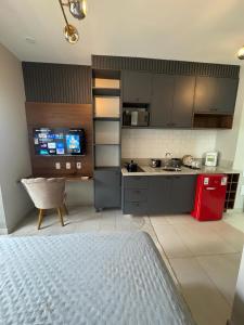 a kitchen with gray cabinets and a red refrigerator at Apartamento 300 m do metrô Tatuapé in São Paulo