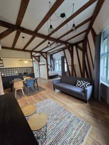 a living room with a couch and a table at Apartamenty toruńskie pod Krzywą Wieżą in Toruń