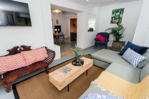 a living room with two couches and a table at 19 Mare St Apartments in Howick