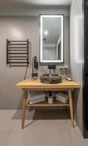 a bathroom with a sink and a mirror at WOL 07 by Ribas in Bukovel