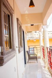 a balcony with a chair on a building at KapeView Elegant Suite in Cape Coast