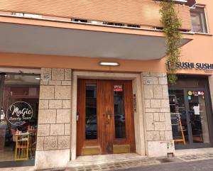 a store with wooden doors on a building at Lilla Eco House - Vaticano in Rome