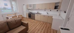 a living room with a couch and a kitchen at Ubytování Lipová in Jihlava