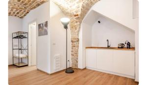 a kitchen with white cabinets and a lamp in a room at CASA GAH in Ripatransone +8 photos