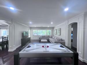 a large living room with a large ping pong table at Destination #03 in Fullerton +43 photos